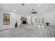 Spacious living room boasts a brick fireplace, high ceilings, and a ceiling fan at 10531 Lakeview Dr, New Port Richey, FL 34654