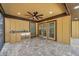 Covered patio featuring brick pavers, ceiling fan, and a built-in bar area with a stainless steel mini-fridge at 10531 Lakeview Dr, New Port Richey, FL 34654