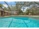 Inviting screened pool area features clear blue water, tile trim, and comfortable poolside seating, offering a relaxing outdoor space at 10531 Lakeview Dr, New Port Richey, FL 34654