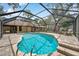 Inviting in-ground pool inside screened enclosure, surrounded by brick patio with outdoor furniture at 10531 Lakeview Dr, New Port Richey, FL 34654