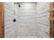Modern shower features stylish tile, stone accents, a rainfall showerhead, and wood trim at 10531 Lakeview Dr, New Port Richey, FL 34654