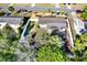 Aerial view of home showing fenced yard, patio area, and mature trees at 1054 Embassy Ave, Spring Hill, FL 34606
