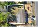 Aerial view of home showcasing a fenced yard, mature landscaping, and well-maintained exterior at 1054 Embassy Ave, Spring Hill, FL 34606