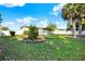 Beautiful backyard surrounded by a white privacy fence and a small sunroom attached to home at 1054 Embassy Ave, Spring Hill, FL 34606