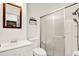 Bathroom with shower, toilet, vanity, and mirror in a room with white walls and cabinetry at 1054 Embassy Ave, Spring Hill, FL 34606