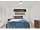 Bedroom with neutral carpet, large window, and ceiling fan at 1054 Embassy Ave, Spring Hill, FL 34606