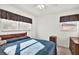 Bedroom featuring two windows with lovely sunlight at 1054 Embassy Ave, Spring Hill, FL 34606
