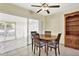 Dining area with table and chairs adjacent to enclosed patio, bright and airy at 1054 Embassy Ave, Spring Hill, FL 34606