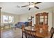 Inviting dining area with tile flooring, ceiling fan and backyard views at 1054 Embassy Ave, Spring Hill, FL 34606