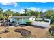 Home with an eye-catching exterior, fenced yard, and meticulous landscaping at 1054 Embassy Ave, Spring Hill, FL 34606