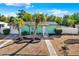 Charming single-story home with a well-manicured, low-maintenance lawn and mature palm trees at 1054 Embassy Ave, Spring Hill, FL 34606