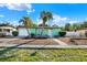 Charming single-story home with a well-manicured lawn and two mature palm trees at 1054 Embassy Ave, Spring Hill, FL 34606