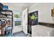 Garage featuring storage shelves, washing machine, tools, and exit door to outside at 1054 Embassy Ave, Spring Hill, FL 34606