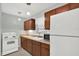 Functional kitchen with white appliances, wood cabinets and ample counter space at 1054 Embassy Ave, Spring Hill, FL 34606