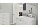 Laundry room featuring modern washing machine and white cabinetry at 1054 Embassy Ave, Spring Hill, FL 34606