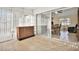 Sunroom with tile flooring, slider to dining room, and wet bar great for entertaining at 1054 Embassy Ave, Spring Hill, FL 34606