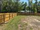 Large lot featuring a newly installed wooden fence and home at 11444 Lake Dr, New Port Richey, FL 34654