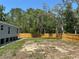 The home is surrounded by a newly installed wooden fence at 11444 Lake Dr, New Port Richey, FL 34654