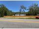 Street view of a light blue home with white trim and a newly constructed wooden fence at 11444 Lake Dr, New Port Richey, FL 34654