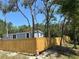 Light blue home with white trim surrounded by a newly installed wooden fence at 11444 Lake Dr, New Port Richey, FL 34654