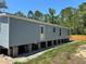 Side view of a light blue home with a white door at 11444 Lake Dr, New Port Richey, FL 34654