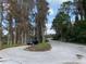 Curving road lined with trees and a parked car at 11444 Lake Dr, New Port Richey, FL 34654
