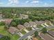 An aerial view captures the neighborhood's layout, featuring manicured lawns and tree-lined streets at 12004 Valley Falls Loop, Spring Hill, FL 34609