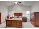 Spacious bedroom features vaulted ceilings, ceiling fan, two windows and wooden furniture at 12004 Valley Falls Loop, Spring Hill, FL 34609