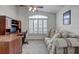 Comfortable bedroom featuring a large window, plush seating, and a built-in desk at 12004 Valley Falls Loop, Spring Hill, FL 34609