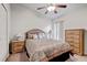 Bedroom with neutral walls, a ceiling fan, and a comfortable bed with a decorative headboard at 12004 Valley Falls Loop, Spring Hill, FL 34609