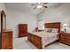 Spacious bedroom features vaulted ceilings, ceiling fan, one window and wooden furniture at 12004 Valley Falls Loop, Spring Hill, FL 34609