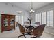 Cozy dining area with a glass table, wicker chairs, and natural light from shuttered windows at 12004 Valley Falls Loop, Spring Hill, FL 34609