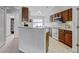 Functional kitchen featuring wood cabinets, modern appliances, and breakfast bar, perfect for casual dining and cooking at 12004 Valley Falls Loop, Spring Hill, FL 34609