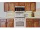 Updated kitchen equipped with modern appliances and wood cabinets, ideal for cooking and meal preparation at 12004 Valley Falls Loop, Spring Hill, FL 34609