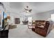 Spacious living room with dining area and plush brown sofas, offering a warm and inviting atmosphere at 12004 Valley Falls Loop, Spring Hill, FL 34609