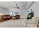 Open-concept living room with vaulted ceilings, neutral carpet, and comfortable seating arrangement perfect for relaxing at 12004 Valley Falls Loop, Spring Hill, FL 34609
