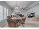 Spacious living room featuring a dining area, comfortable seating, and bright, natural light at 12004 Valley Falls Loop, Spring Hill, FL 34609