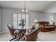 Inviting living space with a glass dining table, cozy seating, and abundant natural light at 12004 Valley Falls Loop, Spring Hill, FL 34609