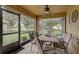 Enclosed patio with tile flooring, ceiling fan and an outdoor dining set, offering relaxing views at 12004 Valley Falls Loop, Spring Hill, FL 34609