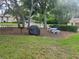 Community amenities with picnic benches, grill, grassy areas, and mature trees at 12119 Sunny Glen Ln # G2, Hudson, FL 34669