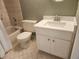Bathroom featuring a tiled tub, toilet, and vanity at 12119 Sunny Glen Ln # G2, Hudson, FL 34669