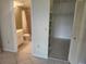 Well-lit bathroom and walk-in closet with tile floors and neutral paint at 12119 Sunny Glen Ln # G2, Hudson, FL 34669