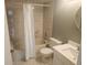 Tiled bathroom with shower-tub combination, white toilet and sink at 12119 Sunny Glen Ln # G2, Hudson, FL 34669