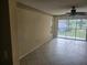 Bedroom with a ceiling fan, sliding glass doors, and a lovely outdoor view at 12119 Sunny Glen Ln # G2, Hudson, FL 34669