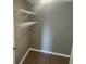 Small closet with wood-look flooring and wire shelving at 12119 Sunny Glen Ln # G2, Hudson, FL 34669