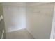 Open closet space with shelving and hanging racks for ample storage solutions at 12119 Sunny Glen Ln # G2, Hudson, FL 34669