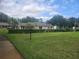 Exterior of the community clubhouse building surrounded by well-maintained lawn and hedges at 12119 Sunny Glen Ln # G2, Hudson, FL 34669