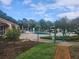 Community pool with lounge chairs, umbrellas, and trees for shade at 12119 Sunny Glen Ln # G2, Hudson, FL 34669