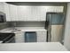 Modern kitchen with stainless steel appliances, white cabinets, and bright countertops at 12119 Sunny Glen Ln # G2, Hudson, FL 34669