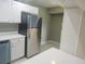 Kitchen view showcasing stainless steel refrigerator, dishwasher and white countertop at 12119 Sunny Glen Ln # G2, Hudson, FL 34669